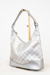 Silver handbag with Gucci pattern on a white background