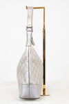 Silver handbag with gold accents on a white background