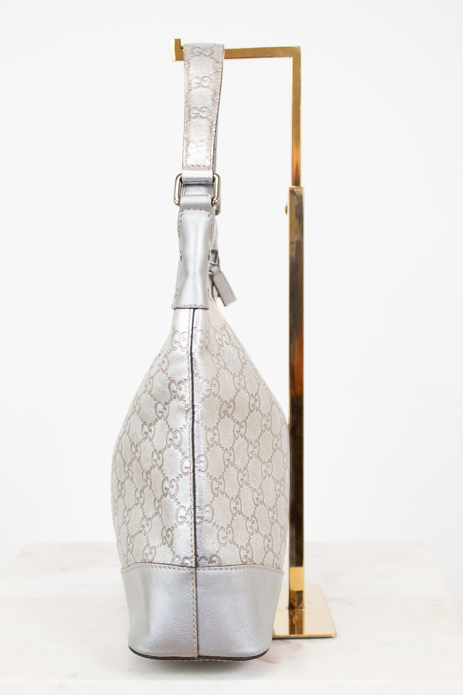 Silver handbag with gold accents on a white background