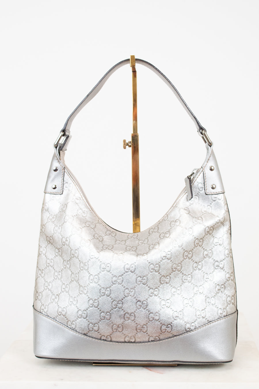 Silver Gucci handbag on a white background