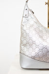Silver Gucci handbag with logo pattern on a white background