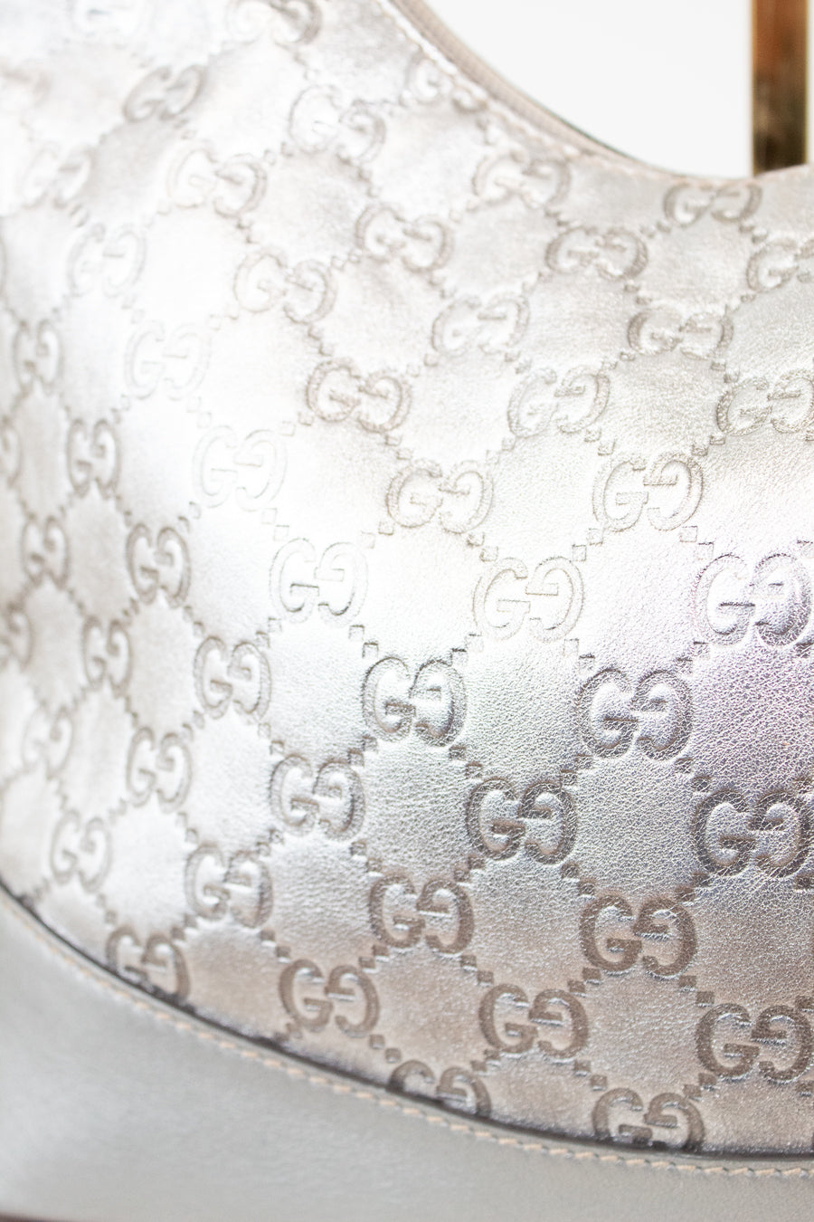 Close-up of a Gucci handbag with monogram pattern