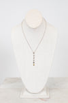 Necklace displayed on a mannequin bust against a white background