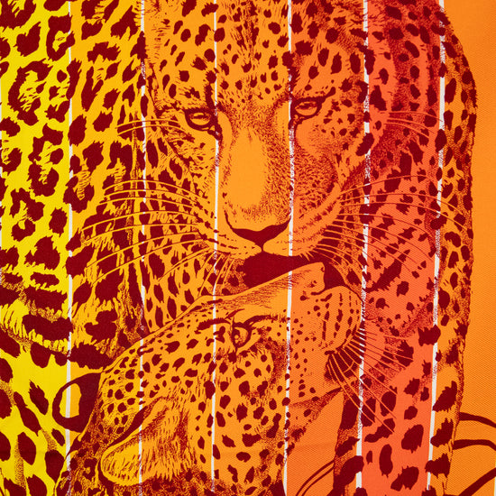 Leopard with a colorful abstract scarf on an orange background