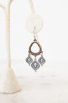 Bronze and silver earrings on a white background