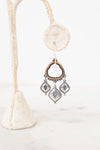 Back view of bronze and silver earrings on a white background
