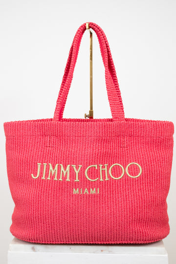 Pink tote bag with 'Jimmy Choo Miami' text on a white background