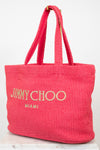 Pink woven handbag with 'Jimmy Choo Miami' text on a white background