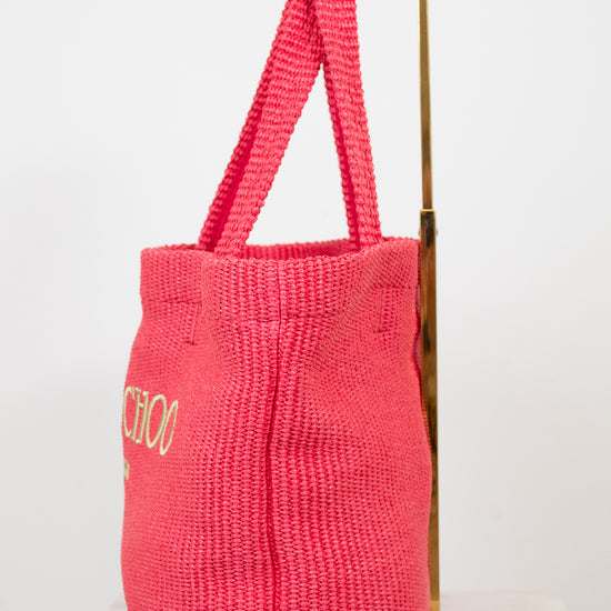 Pink woven bag with 'Jimmy Choo' branding on a white background