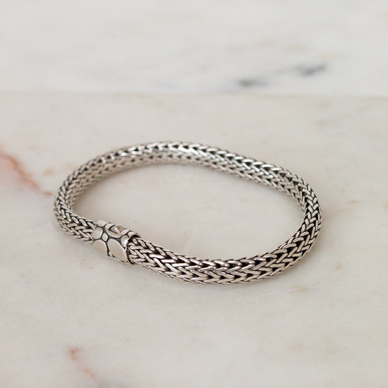 Silver bracelet on a marble surface