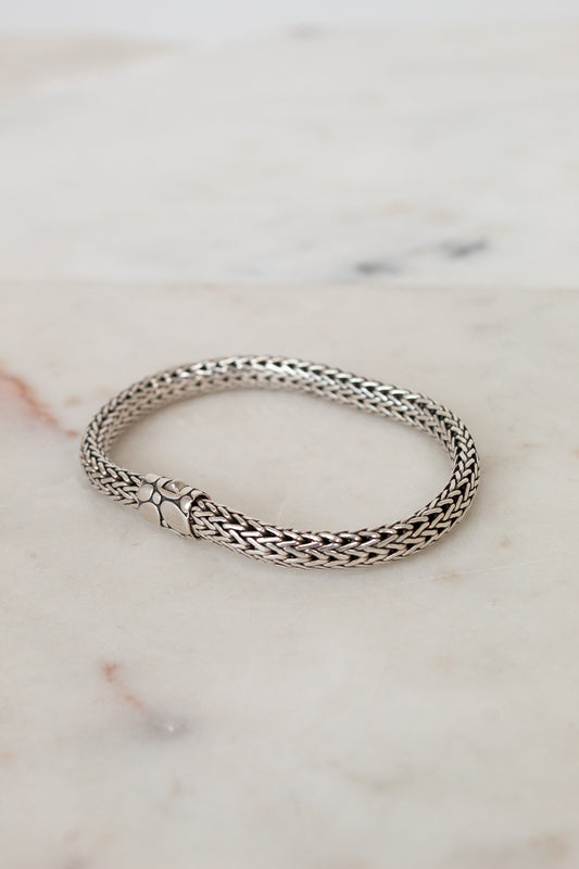 Silver bracelet on a marble surface