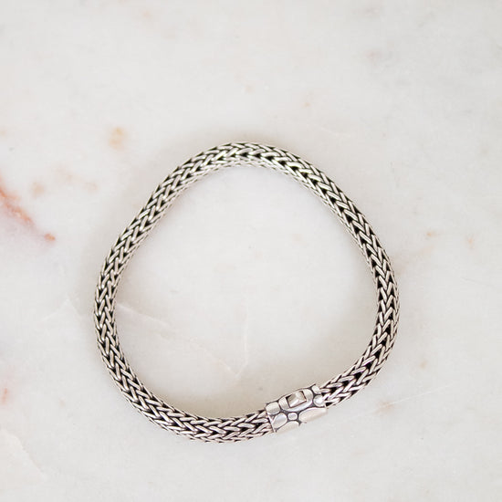 Silver bracelet on a marble surface
