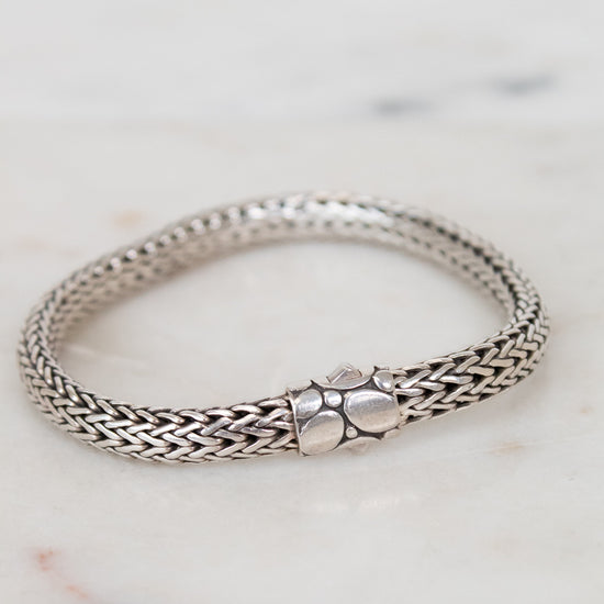 Silver bracelet on a marble surface
