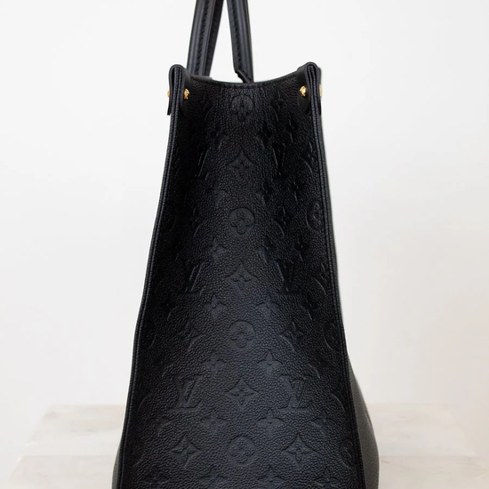 Black textured handbag on a white background