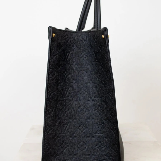 Black embossed handbag on a white background