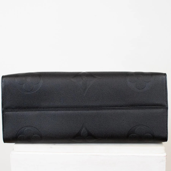 Bottom of black bag with a subtle pattern on a white background