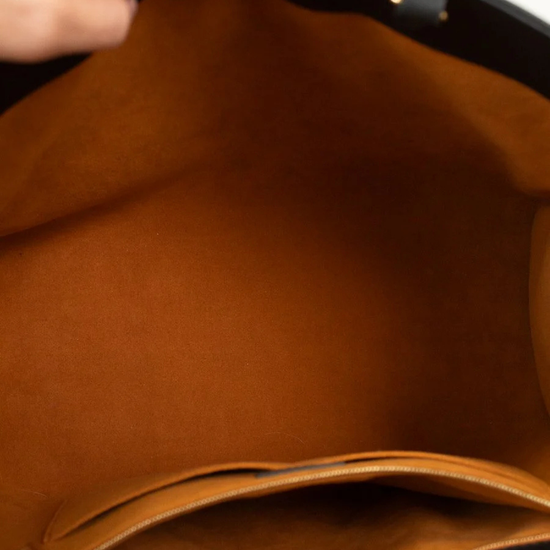 Close-up of interior brown suede with a hand holding it open.