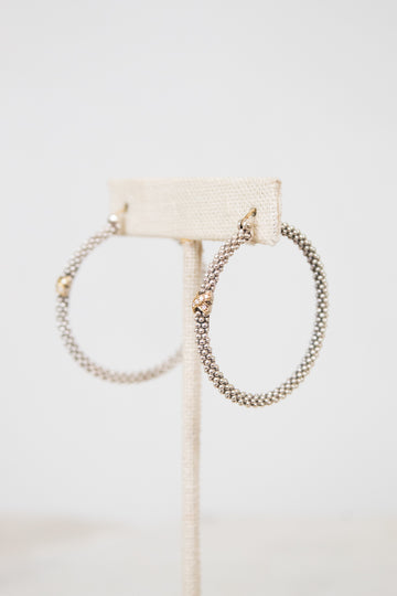 Silver hoops with gold accent on white background
