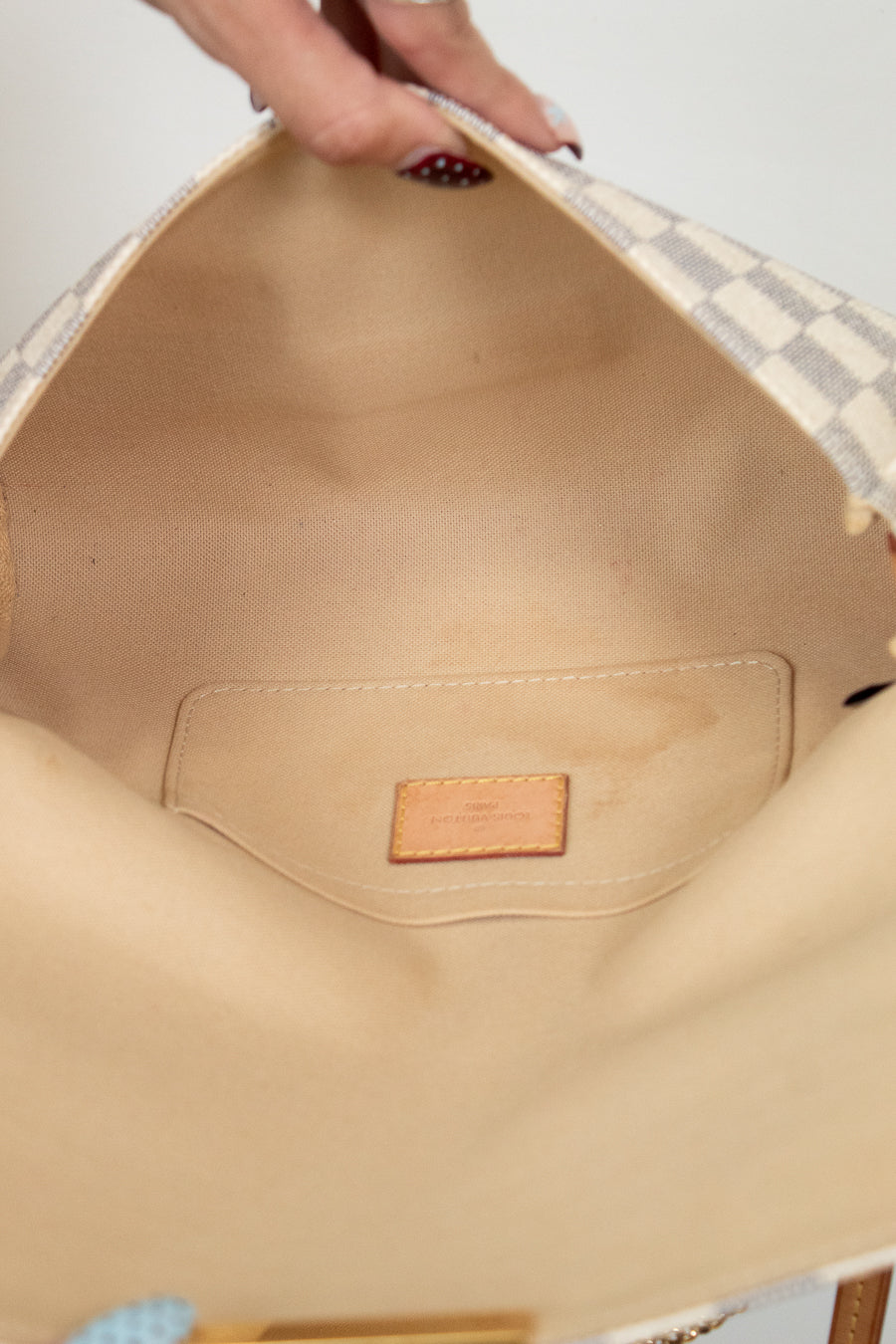 Close-up of a beige interior of a bag with a brand label.