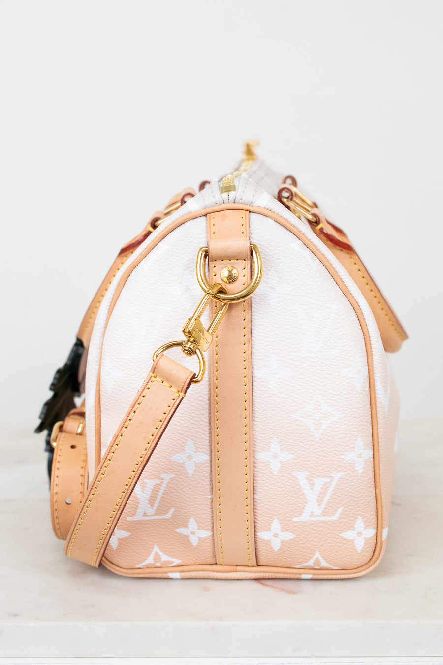 Designer handbag with visible brand logo on a light background