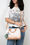 Person holding a Louis Vuitton handbag with a white background