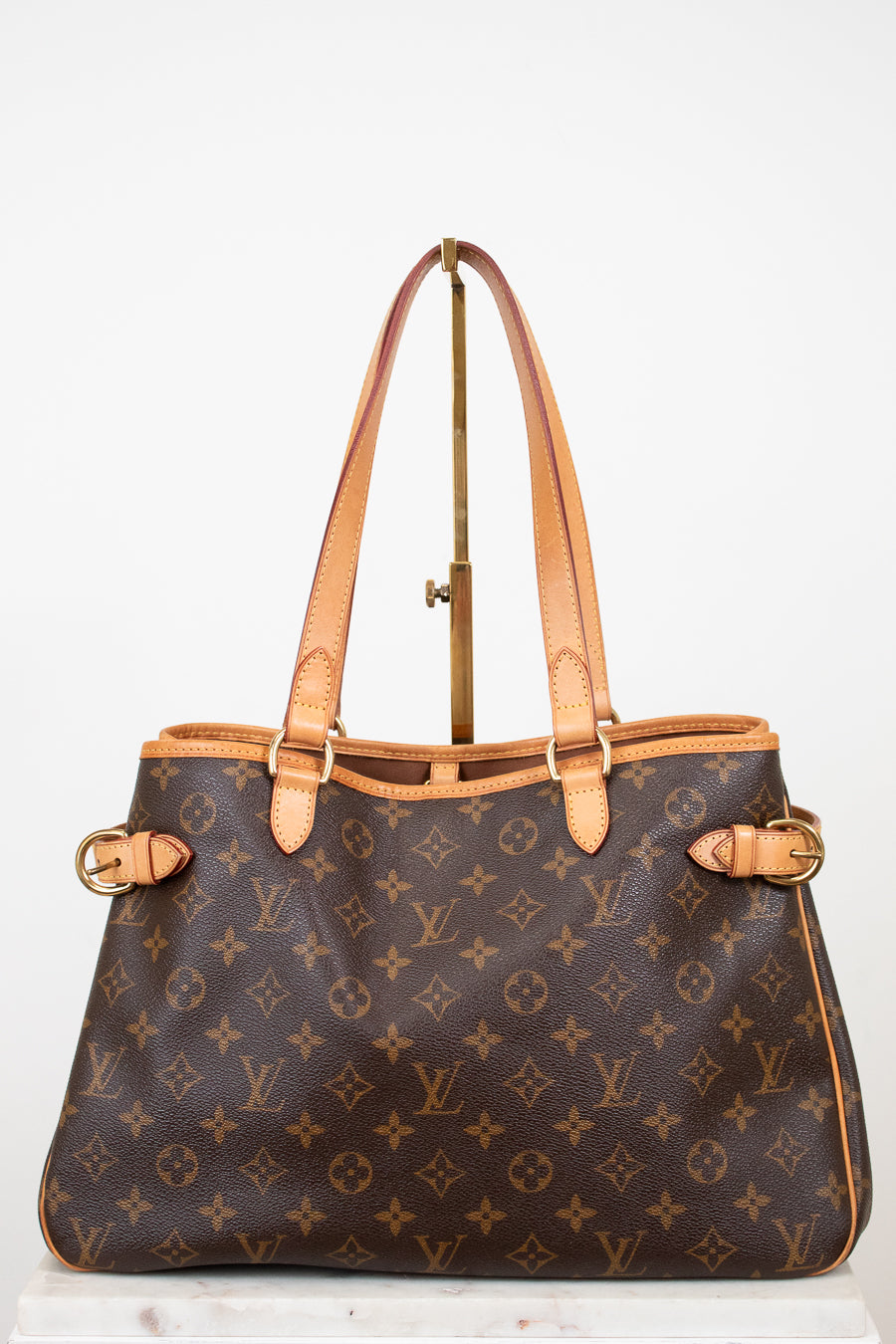 Designer handbag with monogram pattern on a white background