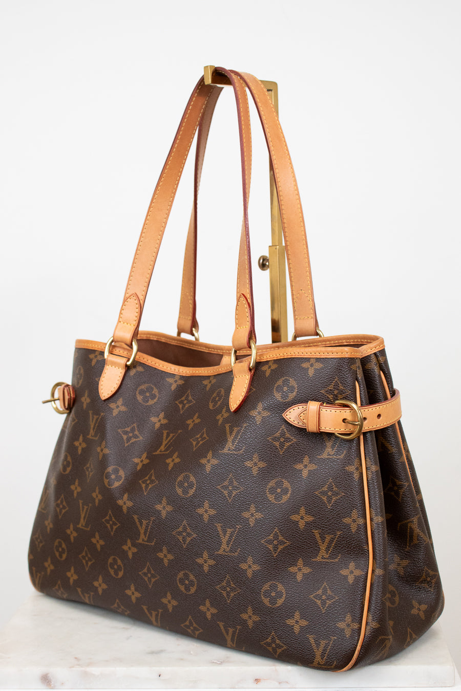 Designer handbag with monogram pattern on a white background