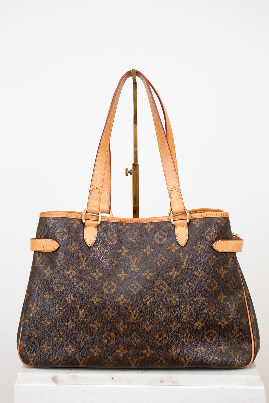 Designer handbag with monogram pattern on a white background