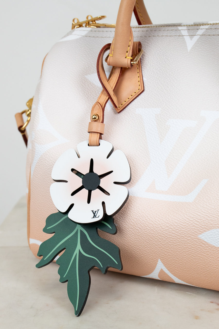 Floral design luggage tag on a handbag with a white background