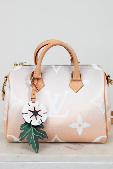 Handbag with a floral keychain on a light background