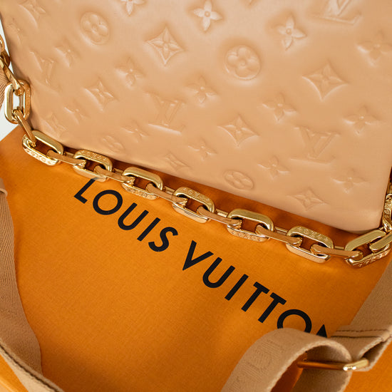 Louis Vuitton beige handbag on orange box with brand logo