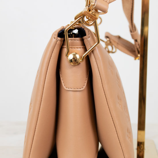 Beige handbag with gold clasp on a white background