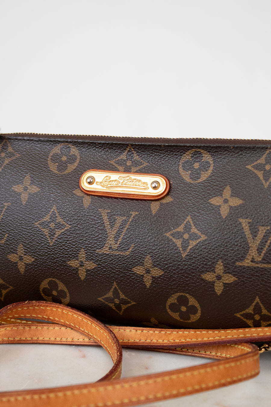 Louis Vuitton handbag with monogram pattern on a light background