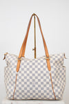 Checkered handbag with brown straps on a white background
