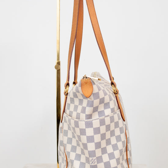 Checkered handbag with brown straps on a white background