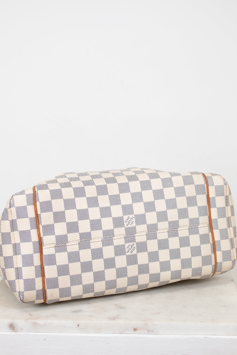 Checkered handbag with visible brand logo on a light background