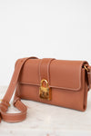 Brown handbag with gold lock on a light background
