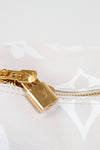 Gold padlock with a visible brand logo on a white textured background