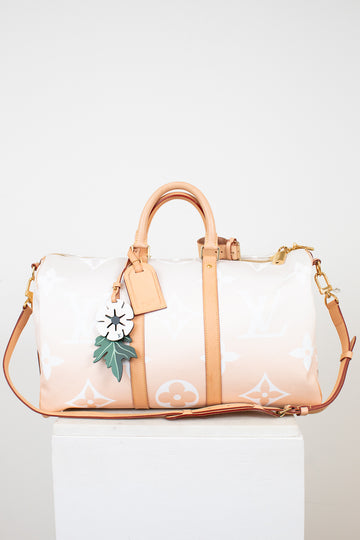 Designer handbag with floral design on a white background