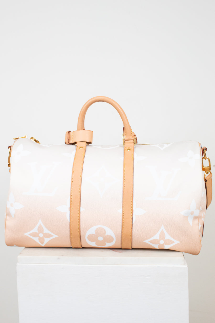 Designer handbag with a gradient design on a white background