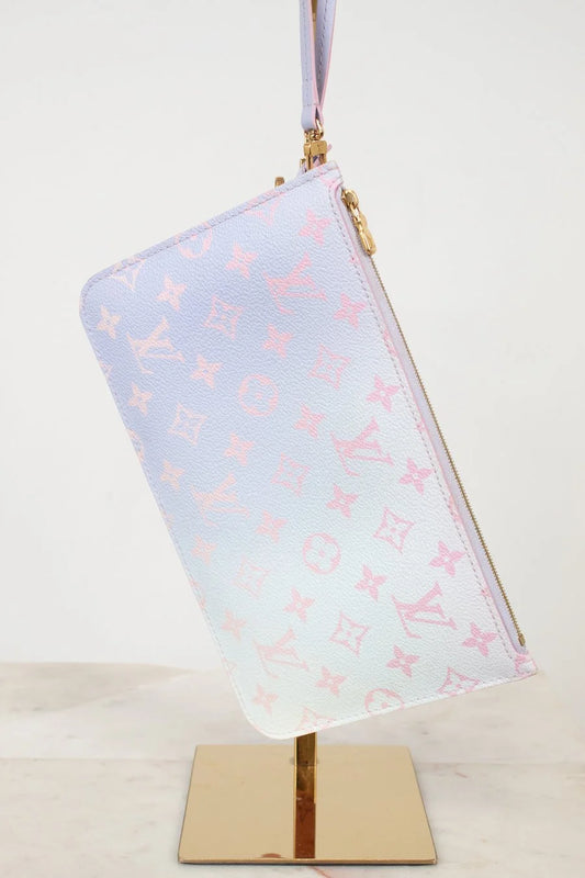 Ombre pink and blue pouch with pink and blue pattern on a stand against a white background