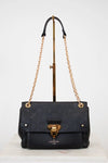 Black handbag with gold chain and hardware on a white background