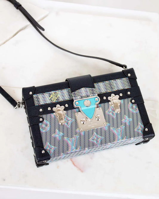 Handbag with decorative clasp on a white background