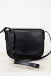 Black leather crossbody bag on a light gray background