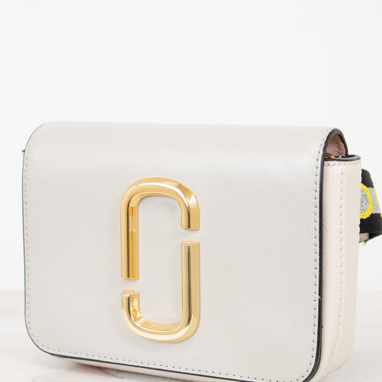 White handbag with gold logo on a white background
