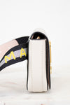 Close-up of a side of bag with 'Marc Jacobs' on the strap against a white background
