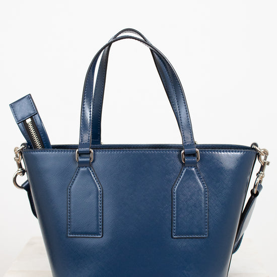 Blue leather handbag with a strap on a white background
