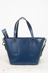 Blue leather handbag with a strap on a white background