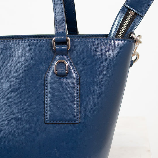 Blue handbag with visible brand name on a white background