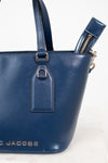 Blue handbag with visible brand name on a white background